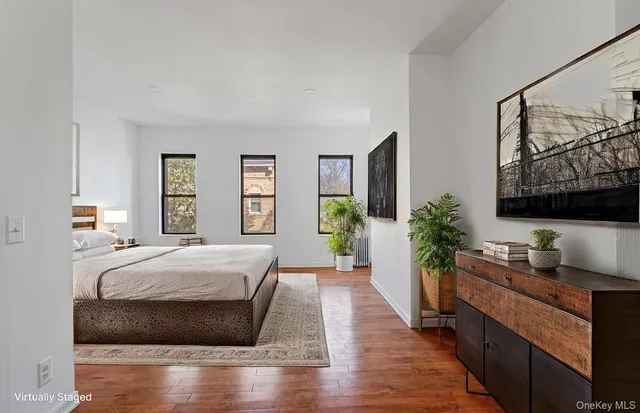 a bedroom with a bed and a flat screen television