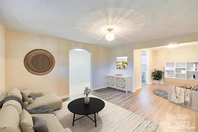 a living room with furniture a rug and a chandelier