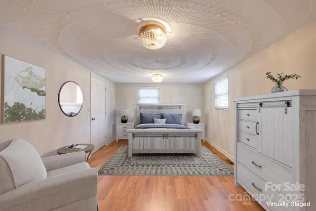 a bedroom with a bed and a chandelier