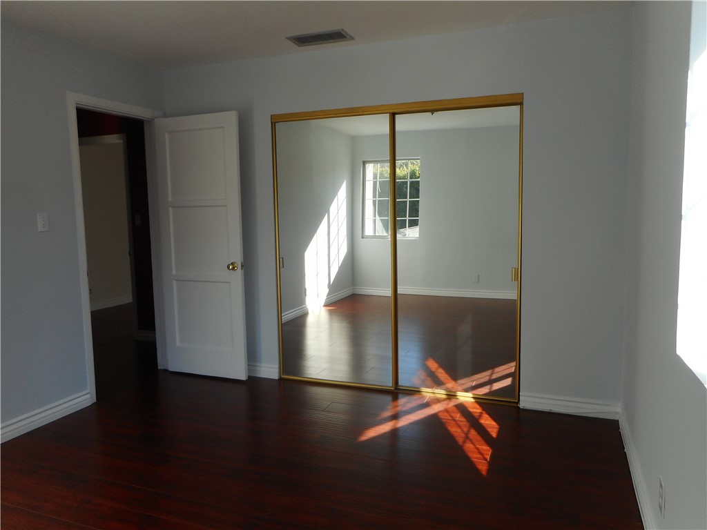 4267 Van Nuys Boulevard Sherman Oaks, CA 91403 - Photo 11 of 17 an empty room with wooden floor and door