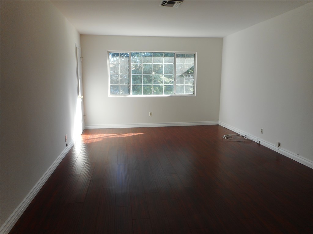 4267 Van Nuys Boulevard Sherman Oaks, CA 91403 - Photo 4 of 17 an empty room with wooden floor and windows