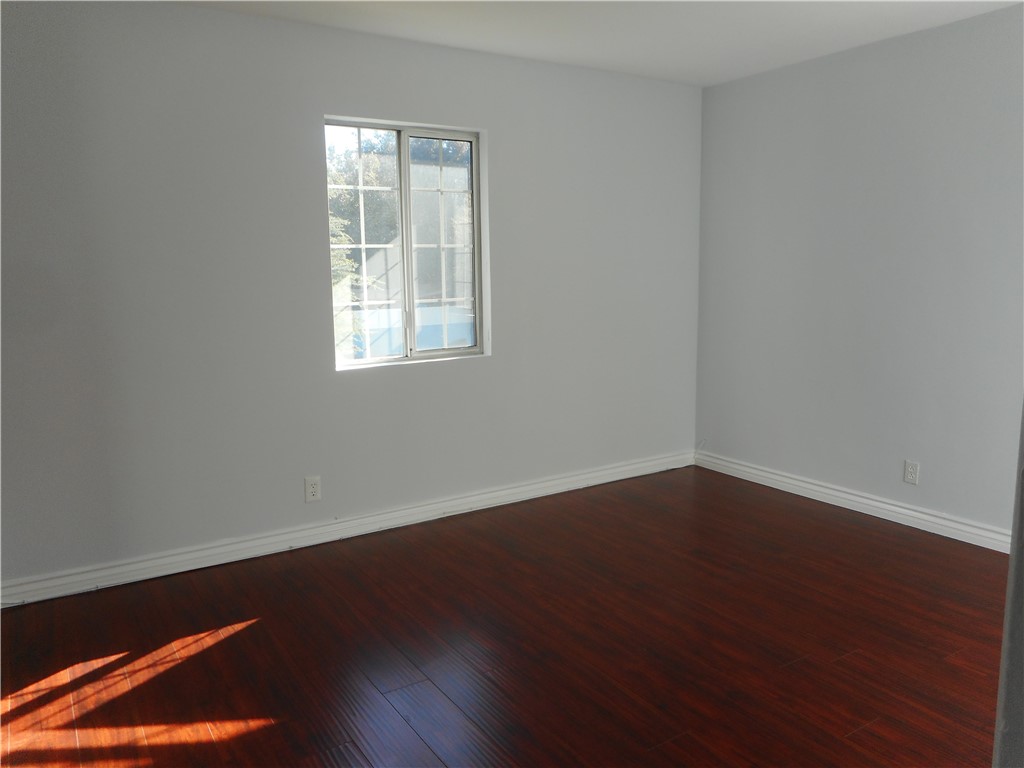 4267 Van Nuys Boulevard Sherman Oaks, CA 91403 - Photo 10 of 17 an empty room with wooden floor and windows