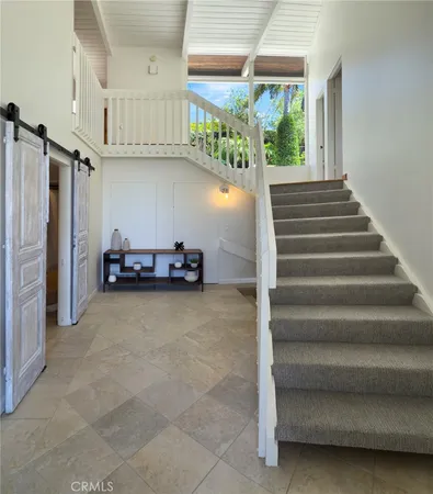 a view of a room with stairs and a window