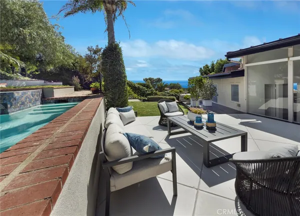 a view of yard from deck with patio