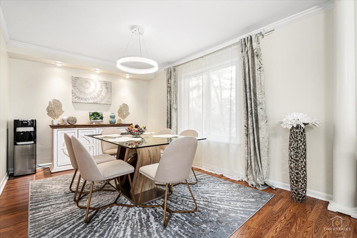 1405 East Central Road, Unit 222C Arlington Heights, IL 60005 - Photo 11 of 45 a dining room with furniture and wooden floor