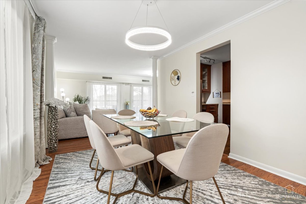 1405 East Central Road, Unit 222C Arlington Heights, IL 60005 - Photo 12 of 45 a view of a dining room with furniture and wooden floor
