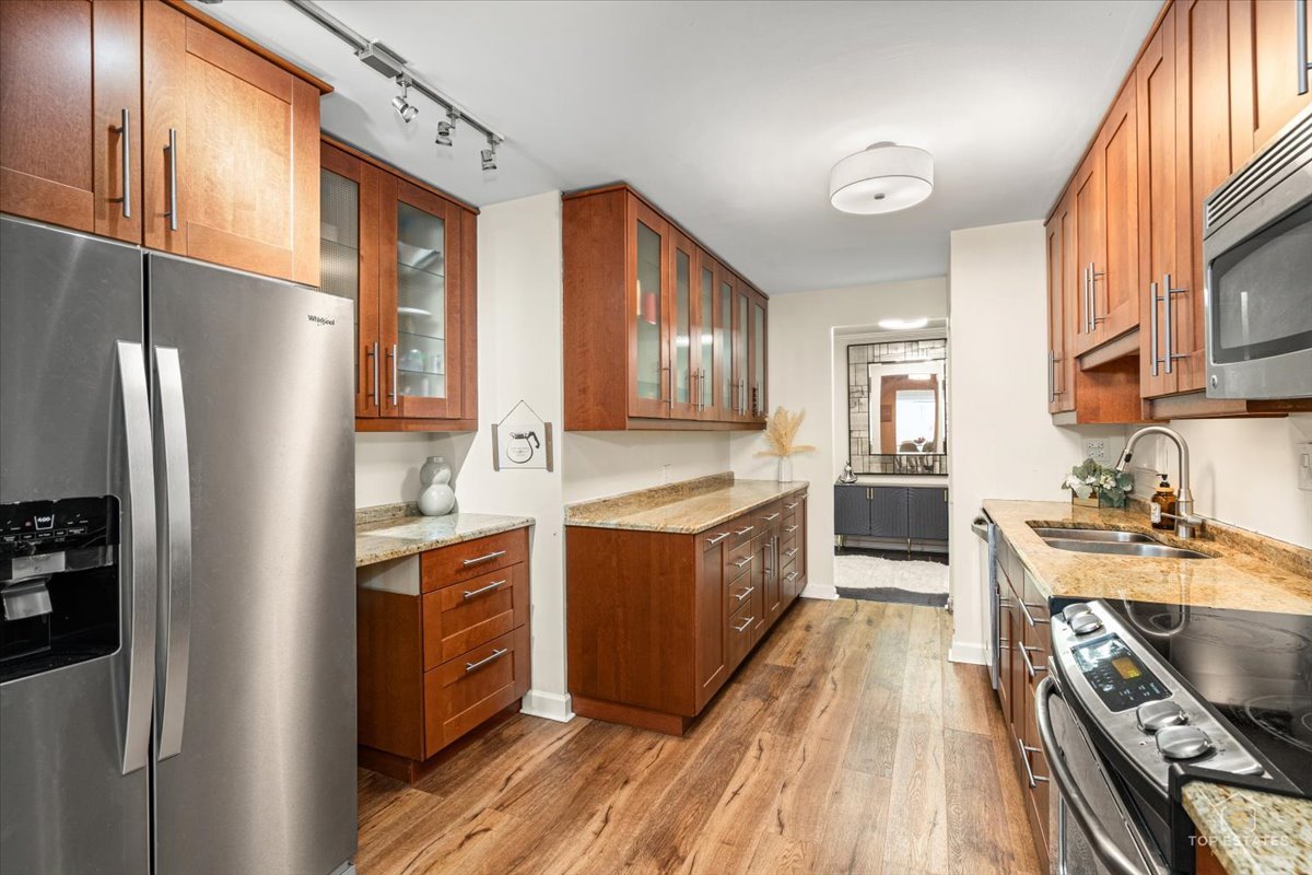 1405 East Central Road, Unit 222C Arlington Heights, IL 60005 - Photo 14 of 45 a kitchen with stainless steel appliances granite countertop a stove a refrigerator and a refrigerator