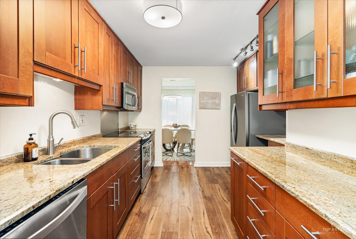1405 East Central Road, Unit 222C Arlington Heights, IL 60005 - Photo 17 of 45 a kitchen with stainless steel appliances granite countertop a sink and a stove
