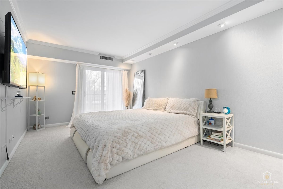 1405 East Central Road, Unit 222C Arlington Heights, IL 60005 - Photo 21 of 45 a bedroom with a bed and a window