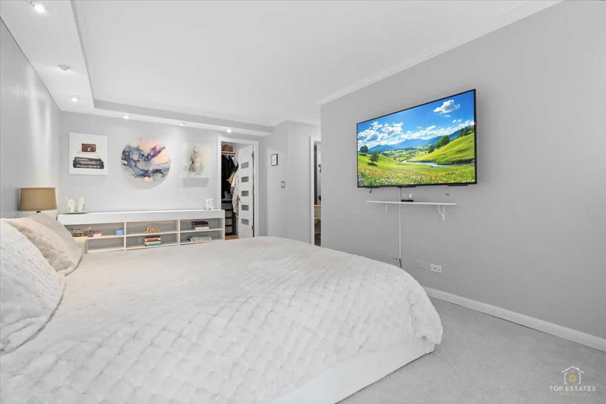 1405 East Central Road, Unit 222C Arlington Heights, IL 60005 - Photo 23 of 45 a bedroom with a bed and a flat screen tv