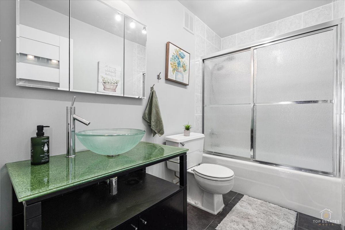 1405 East Central Road, Unit 222C Arlington Heights, IL 60005 - Photo 28 of 45 a bathroom with a sink a toilet and shower
