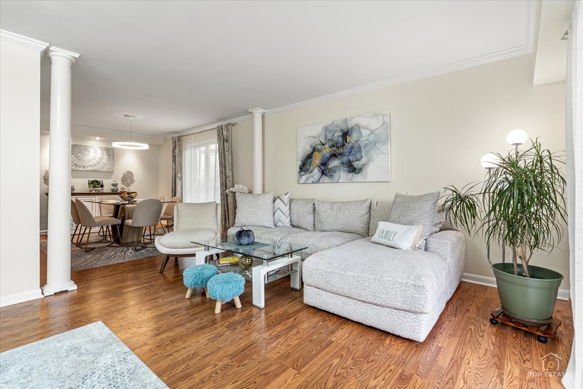 1405 East Central Road, Unit 222C Arlington Heights, IL 60005 - Photo 10 of 45 a living room with furniture and a wooden floor