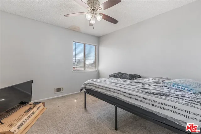 a bedroom with bed and window