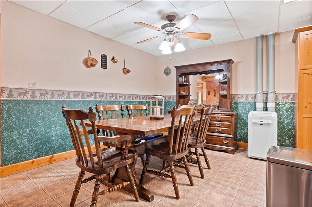 1850 Carter Road Volant, PA 16156 - Photo 12 of 23 a view of a dining room and livingroom with furniture wooden floor a rug a painting and a chandelier