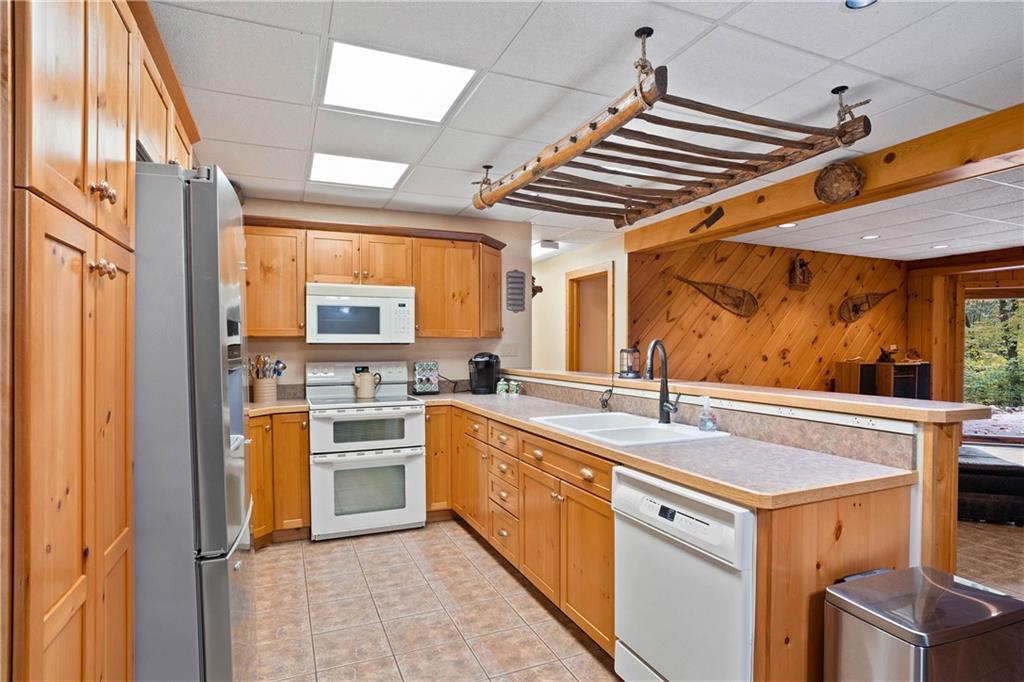 1850 Carter Road Volant, PA 16156 - Photo 14 of 23 a kitchen with a stove a sink and a refrigerator