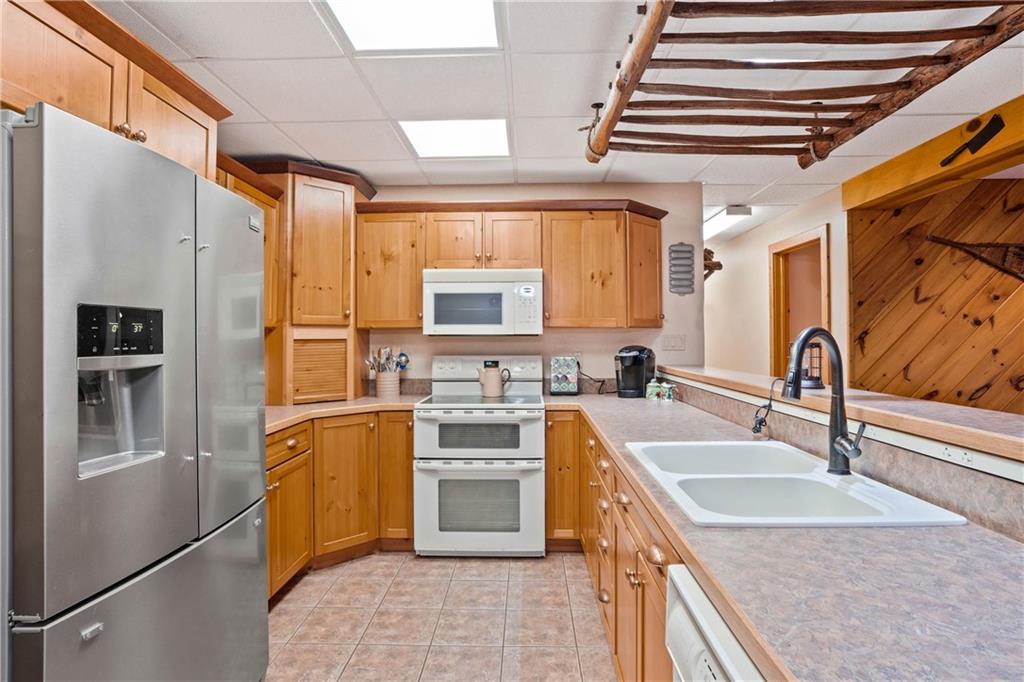1850 Carter Road Volant, PA 16156 - Photo 15 of 23 a kitchen with stainless steel appliances granite countertop a sink stove and refrigerator