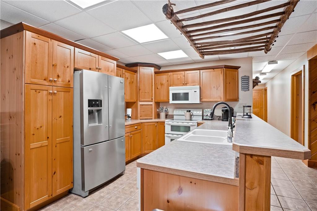 1850 Carter Road Volant, PA 16156 - Photo 16 of 23 a kitchen with stainless steel appliances granite countertop a refrigerator a sink and a stove