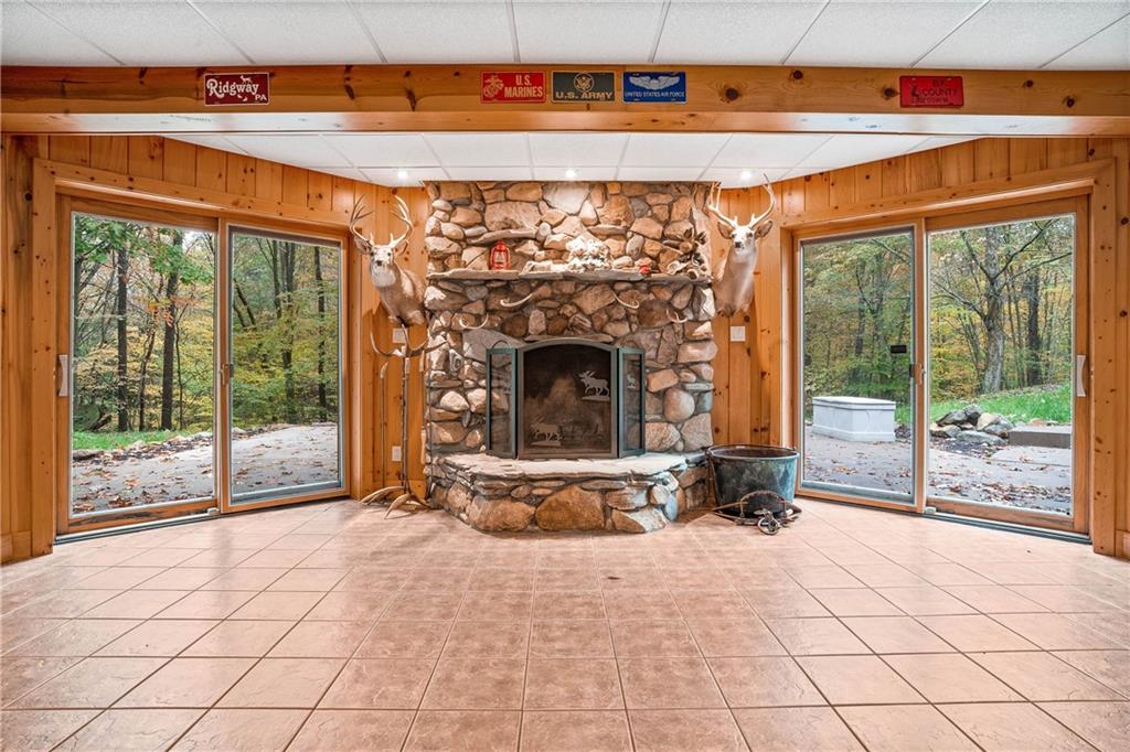 1850 Carter Road Volant, PA 16156 - Photo 10 of 23 a view of an empty room with a fireplace and windows