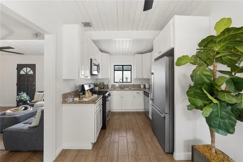 a kitchen with a sink stainless steel appliances and cabinets