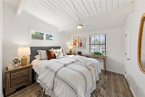 a bed room with a bed window and wall painting