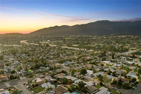an aerial view of residential houses with outdoor space and trees