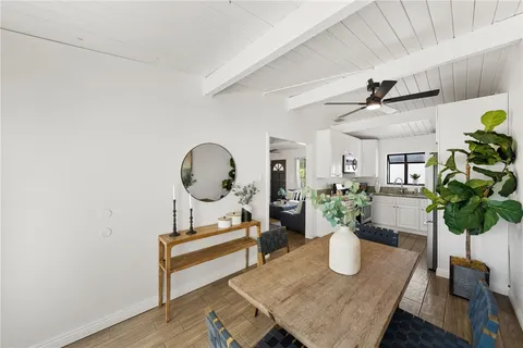 a living room with furniture flowers and a potted plant