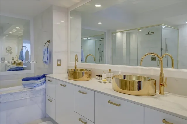 a bathroom with a granite countertop sink a mirror and shower