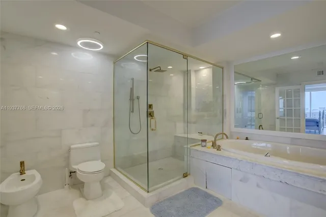 a bathroom with a shower sink mirror and a bathtub