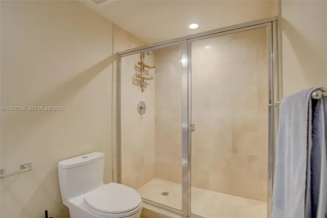 a white toilet sitting next to a bathroom sink