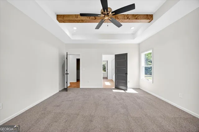 a bathroom with a granite countertop sink a mirror a bathtub and shower