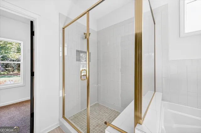 a bathroom with a bathtub and a shower