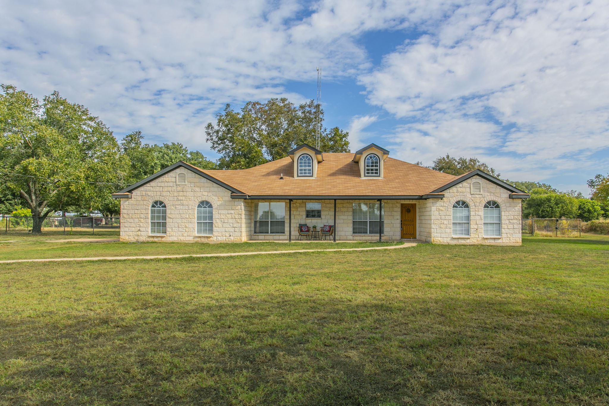 a front view of a house with a garden