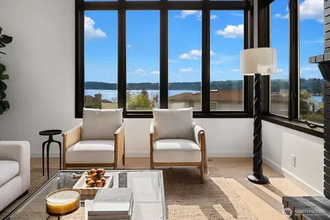 a living room with furniture and a floor to ceiling window