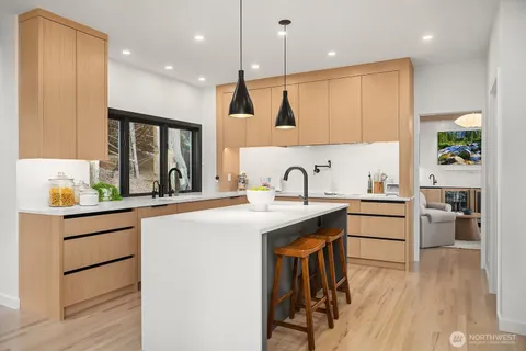 a large kitchen with a sink and cabinets