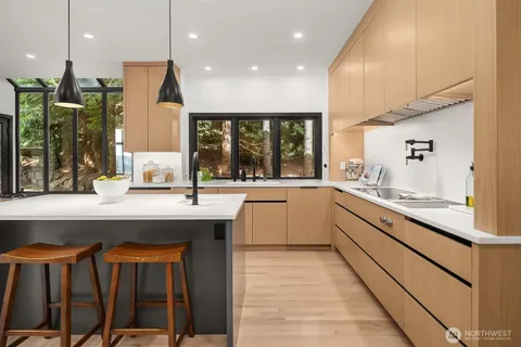 a kitchen with a sink a counter top space stainless steel appliances and cabinets
