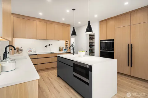 a kitchen with a sink appliances and cabinets