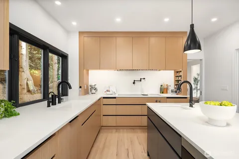 a kitchen with a table chairs sink and cabinets
