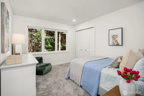 a bed room with a bed and a night stand