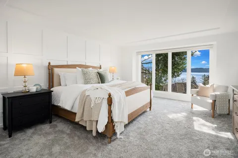 a bedroom with a bed and a large window