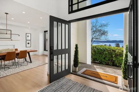 a living room with large window and a table
