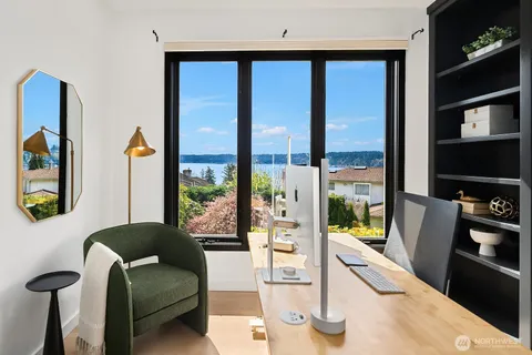 a living room with furniture a floor to ceiling window and a flat screen tv