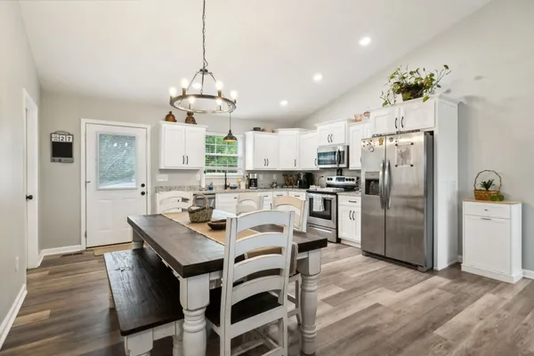 a kitchen with a white cabinets and white appliances