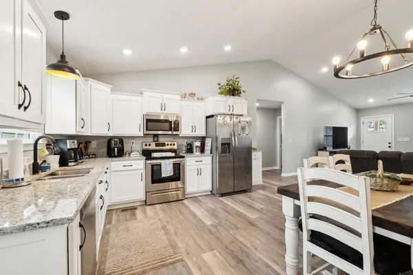 a large kitchen with a table and chairs