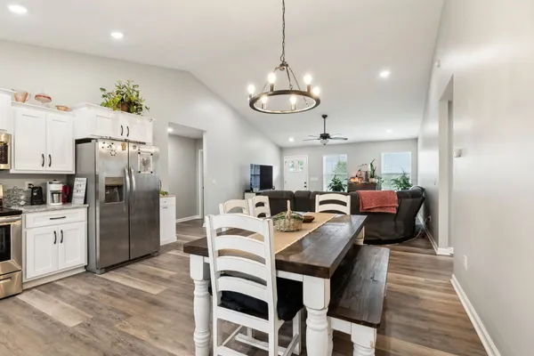 a large kitchen with a table and chairs