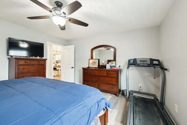 a bedroom with a bed and a chandelier