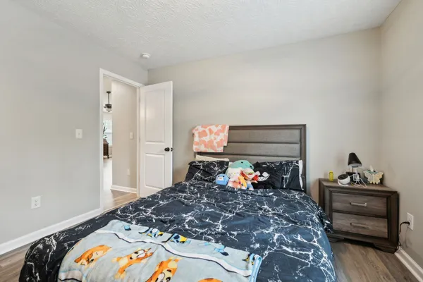 a bedroom with a bed and a dresser in it