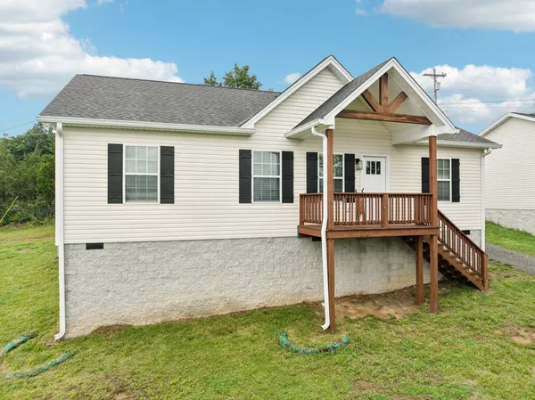 a view of a house with a wooden fence