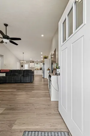 a living room with furniture and a ceiling fan