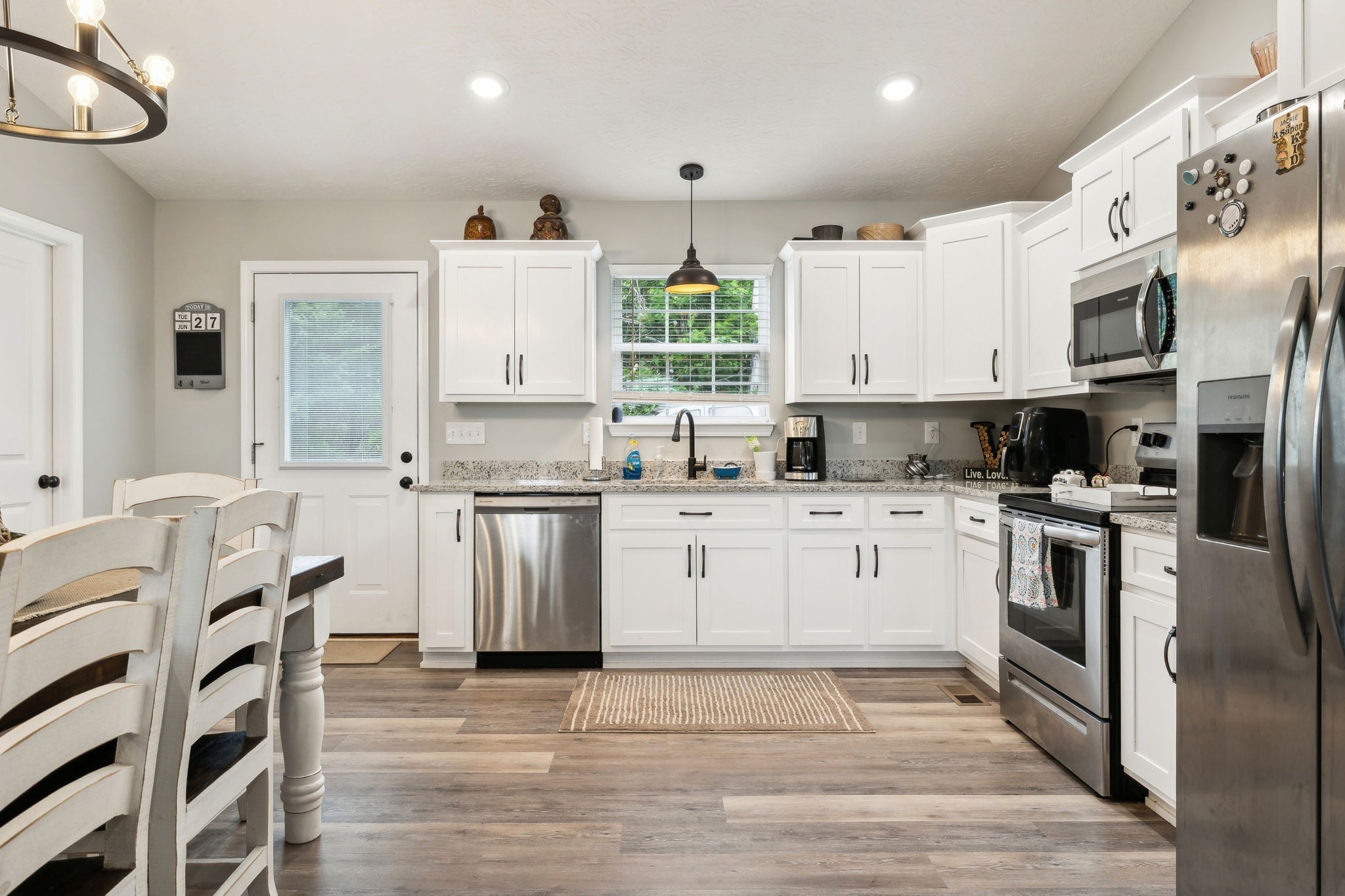 125 Vivian Lane Carthage, TN 37030 - Photo 10 of 29 a kitchen with white cabinets and stainless steel appliances