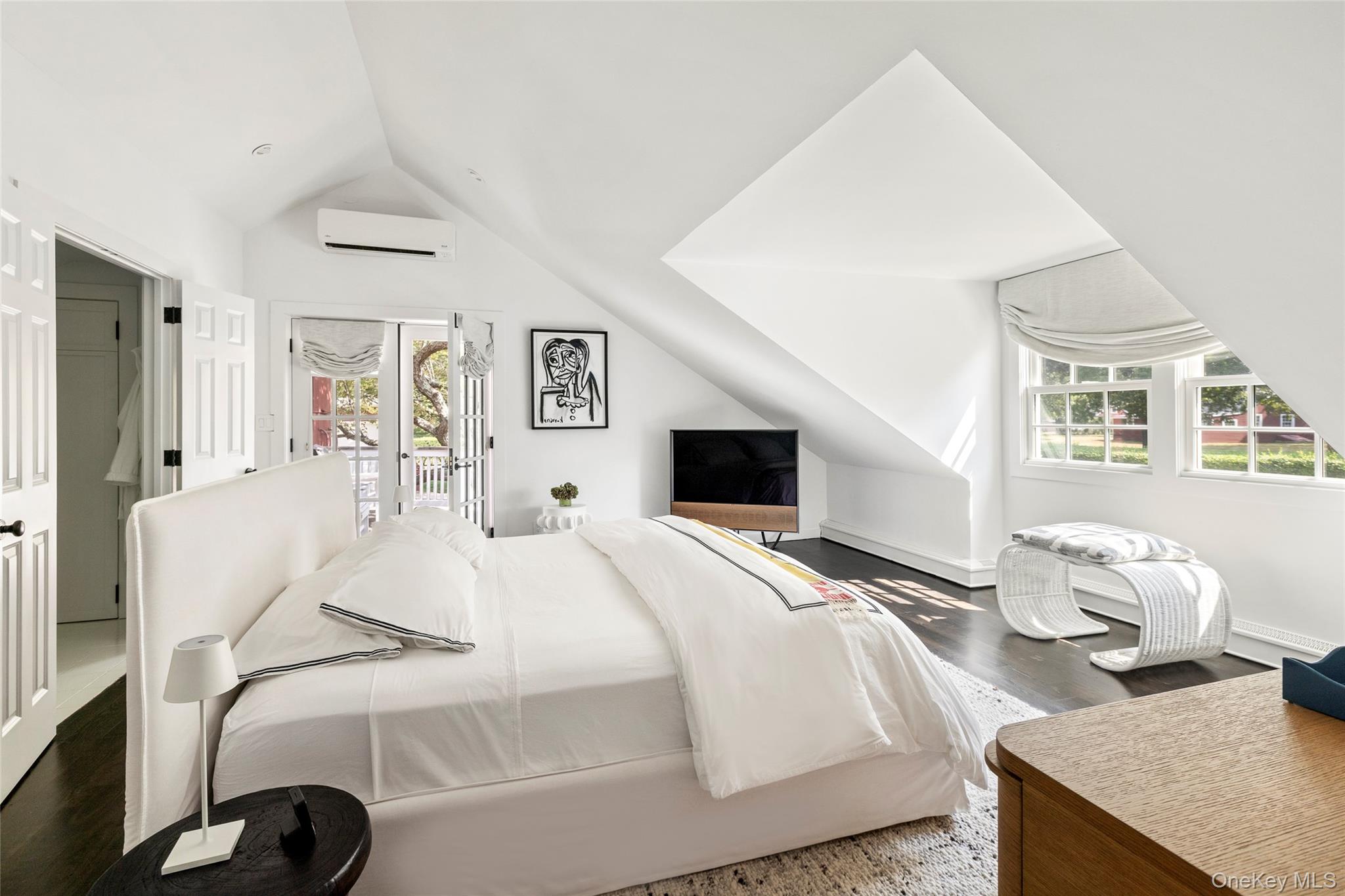 26 Ruxton Road East Hampton, NY 11937 - Photo 24 of 37 Bedroom with lofted ceiling, access to exterior, dark wood-style floors, and a wall mounted AC